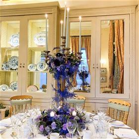 fwthumbCandelabra with coloured candles, purple asparagus fern carnations, clematis.jpg